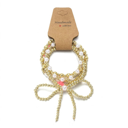 6pc Pink Accented Bow Gold Beaded Bracelet Stack